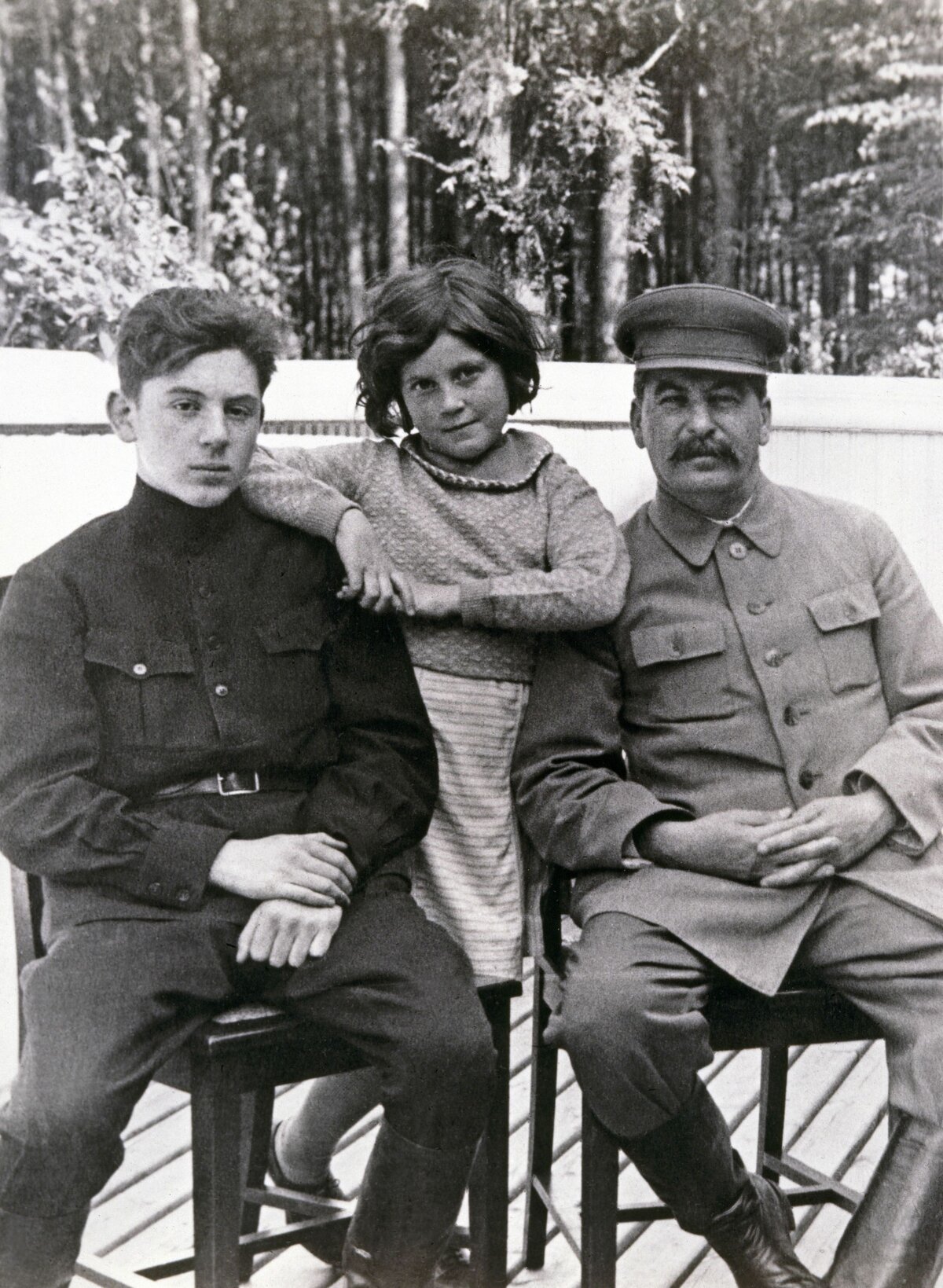 Soviet leader Joseph Stalin (1878 - 1953, right) with his son, Vasily (1921 - 1962) and daughter Svetlana (1926 - 2011) at one of Stalin's dachas, former Soviet Union, June 1935. Both children are by Stalin's second wife, Nadezhda Alliluyeva. The photograph was taken by Stalin's head of personal security, Nikolai Vlasik (1896 - 1967). (Photo by Laski Diffusion/Getty Images)